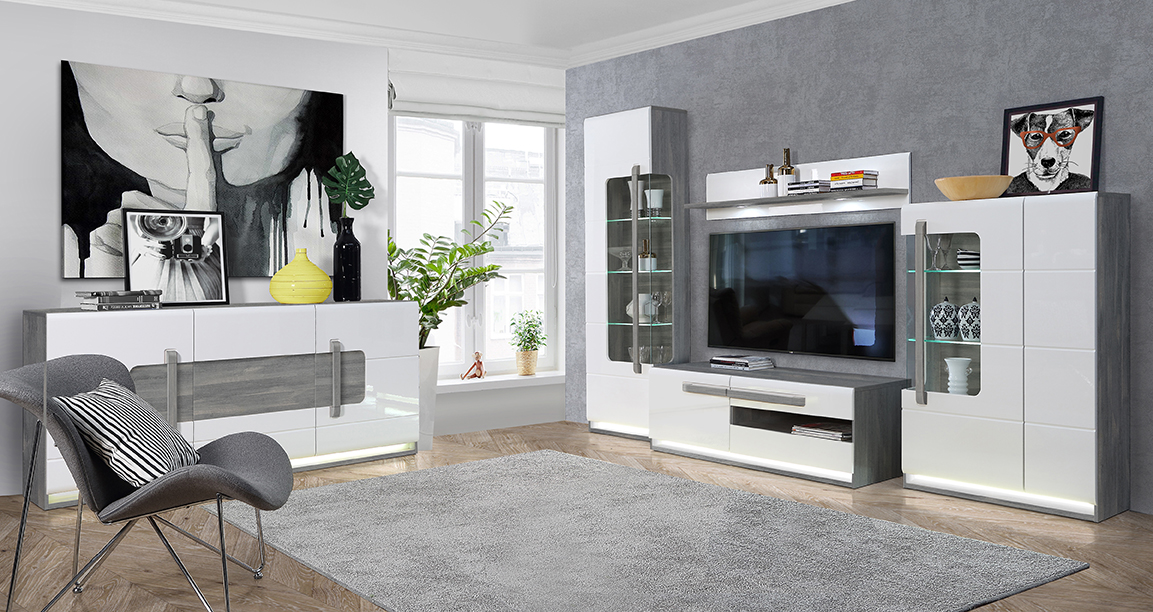 Un salon moderne et élégant, plein de vie et couleurs. Cette décoration met en avant les meubles de la collection ALEXIANE, orné d'un blanc laqué allié à un gris élégant ou un décor de bois clair.