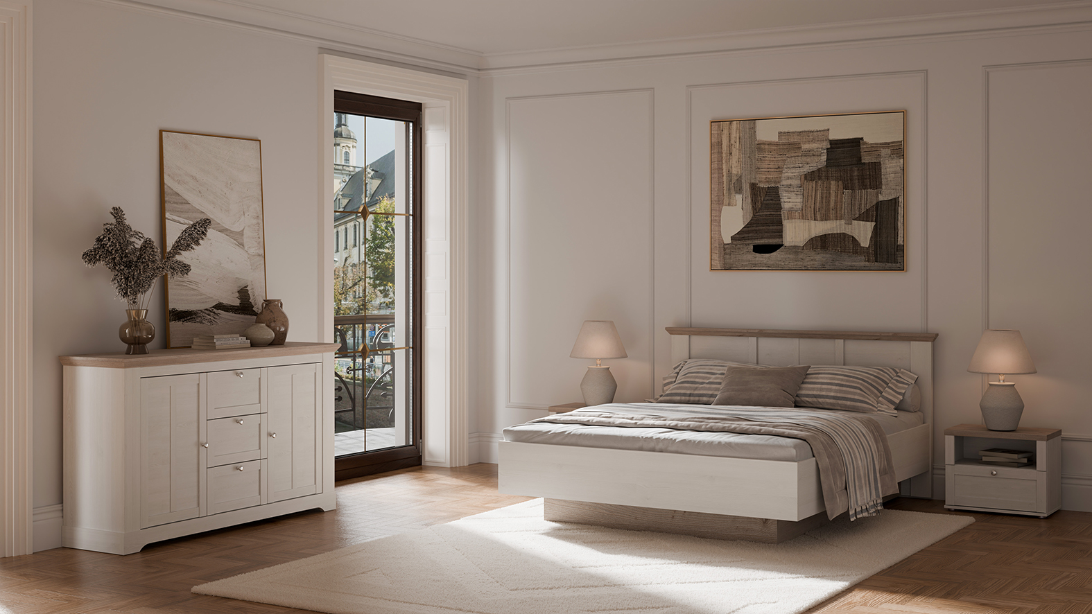 Un chambre à coucher aux murs clairs et une ambiance globale chaude et tamisée. S'y trouvent les meubles de la collection ANGELE, avec leur décor bois de chêne blanchi, apportant un côté bucolique chic et moderne.