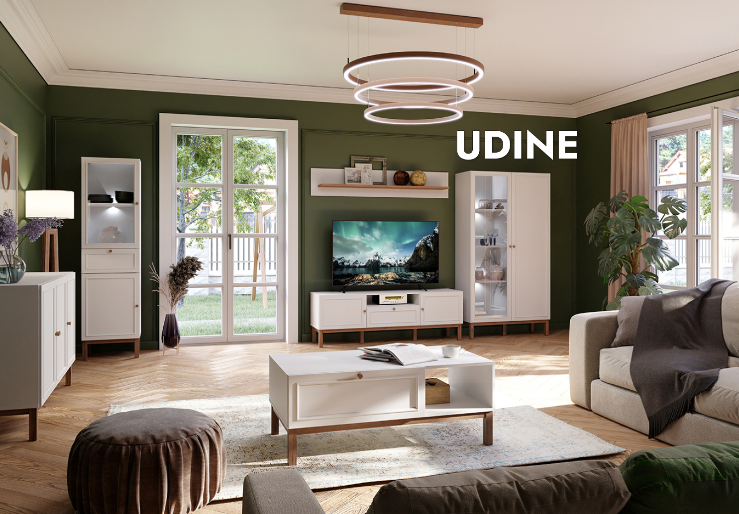  Un salon aussi bucolique qu'élégant grâce à ses murs peints d'une profonde teinte de vert et de moulures au plafond. Les meubles de la collection UDINE y trouvent une place unique grâce à leur blanc raffiné contrasté par une petite touche de décor de bois chaud. 